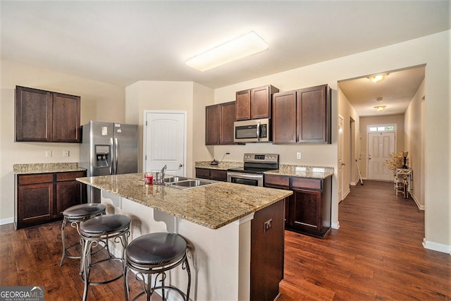 kitchen with dark wood-type flooring, a sink, dark brown cabinetry, and stainless steel appliances