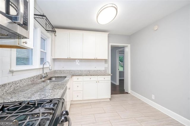 2607 Jefferson Ter, Atlanta, GA 30344 - kitchen featuring appliances with stainless steel finishes, white cabinetry, and light stone counters