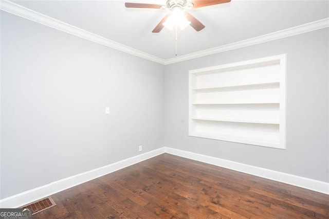 2607 Jefferson Ter, Atlanta, GA 30344 - unfurnished room featuring ornamental molding, built in shelves, ceiling fan, and dark wood-style floors