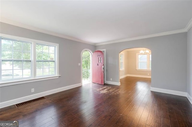 2607 Jefferson Ter, Atlanta, GA 30344 - spare room featuring arched walkways, ornamental molding, hardwood / wood-style flooring, and a chandelier