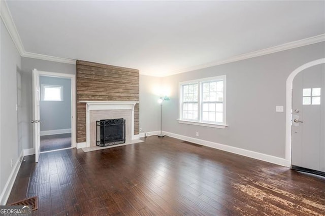 2607 Jefferson Ter, Atlanta, GA 30344 - unfurnished living room with arched walkways, plenty of natural light, a fireplace, ornamental molding, and dark wood-type flooring
