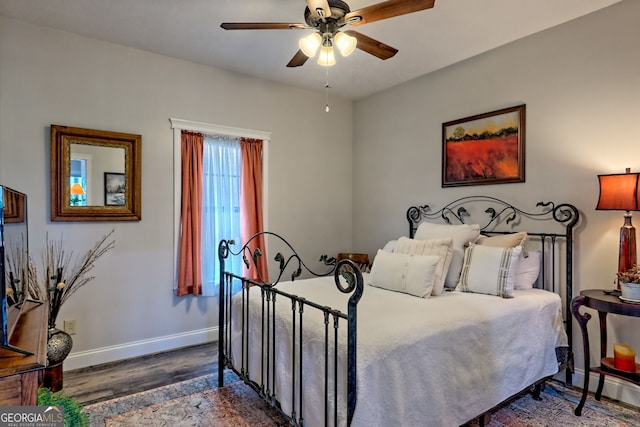 bedroom with wood finished floors, baseboards, and ceiling fan