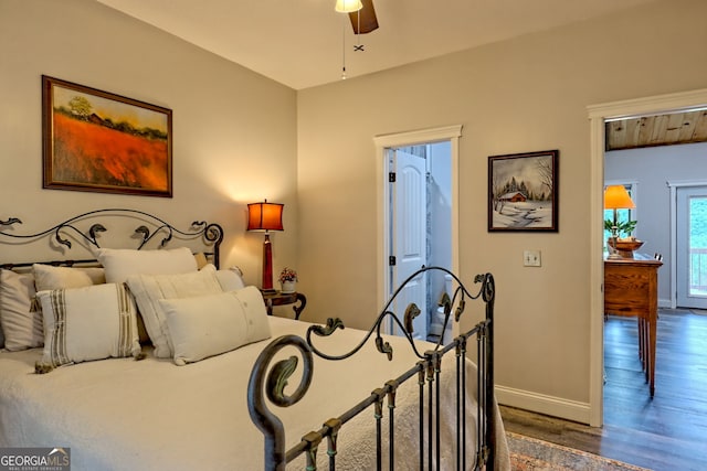 bedroom with dark wood-style floors, baseboards, and ceiling fan