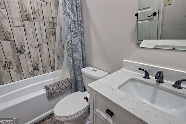 bathroom featuring toilet, shower / bathtub combination with curtain, vanity, and wood finished floors