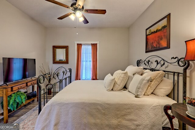 bedroom with wood finished floors and a ceiling fan