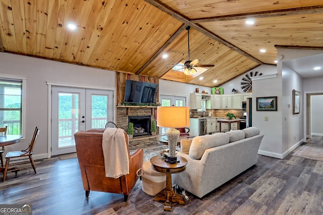 living area with wooden ceiling, baseboards, dark wood-style flooring, a stone fireplace, and recessed lighting