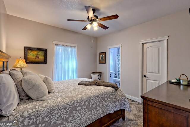 bedroom with connected bathroom, baseboards, a ceiling fan, and carpet floors