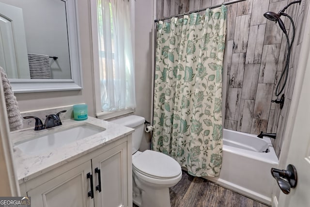 full bathroom featuring toilet, shower / tub combo with curtain, wood finished floors, and vanity