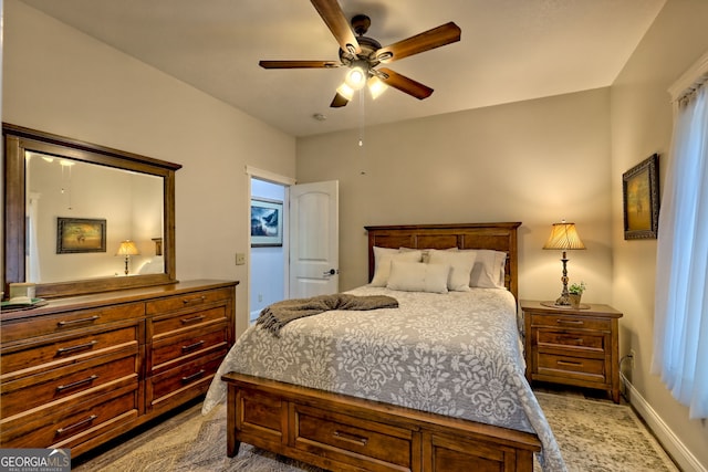 bedroom with a ceiling fan and baseboards