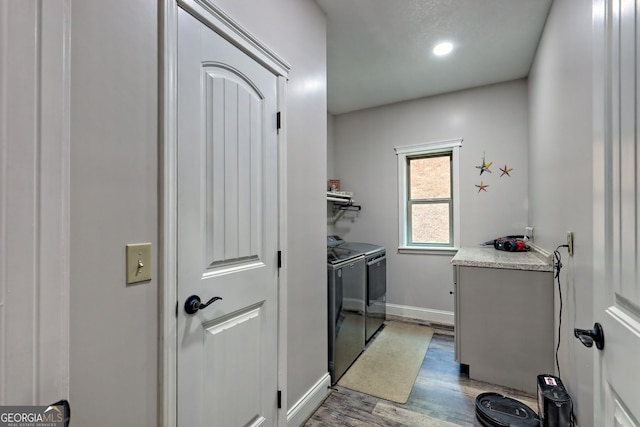 clothes washing area with washer and dryer, light wood-type flooring, baseboards, and recessed lighting