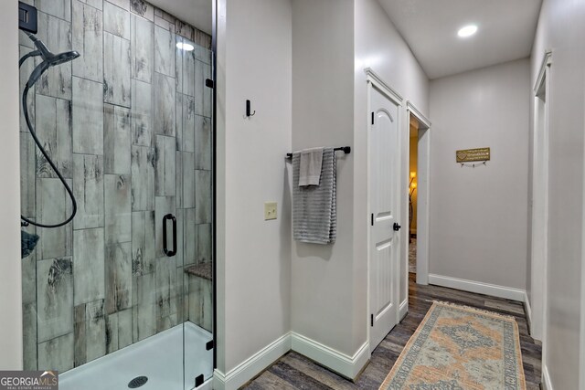 full bath featuring baseboards, a shower stall, vanity, wood finished floors, and recessed lighting