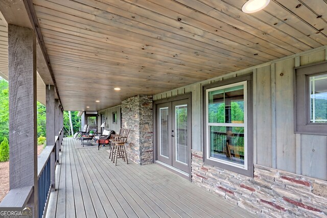 wooden terrace with french doors and covered porch