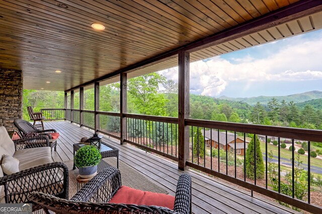wooden terrace with a mountain view and a wooded view