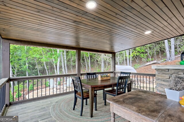wooden deck featuring outdoor dining area