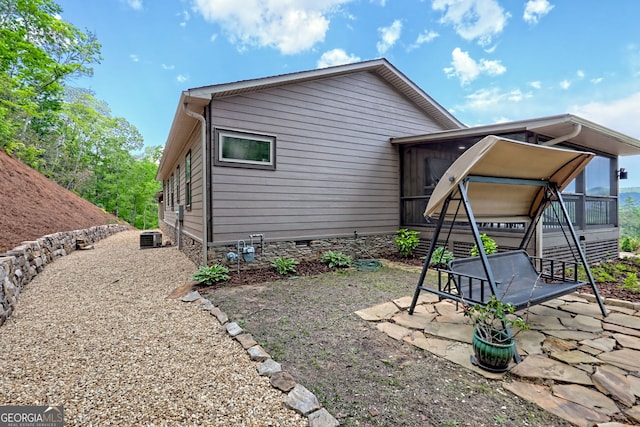 view of side of home featuring a patio area and crawl space