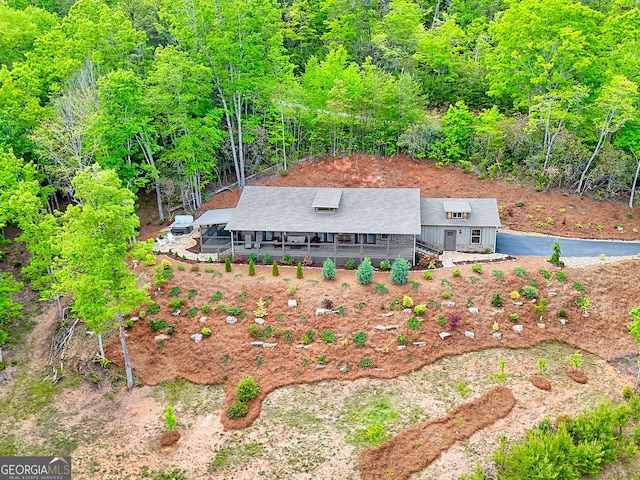 view of subject property with a heavily wooded area