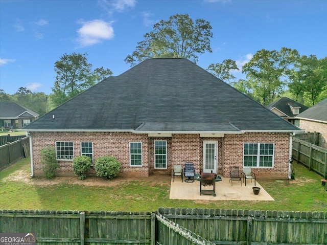 404 Hunts Landing Dr, Kathleen, GA 31047 - back of house with a fenced backyard, a lawn, a patio area, and brick siding