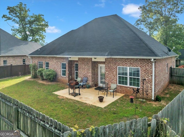 404 Hunts Landing Dr, Kathleen, GA 31047 - back of property featuring brick siding, a fenced backyard, a lawn, and a patio
