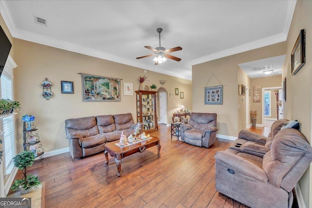 404 Hunts Landing Dr, Kathleen, GA 31047 - living room featuring arched walkways, a ceiling fan, plenty of natural light, and light wood-style flooring