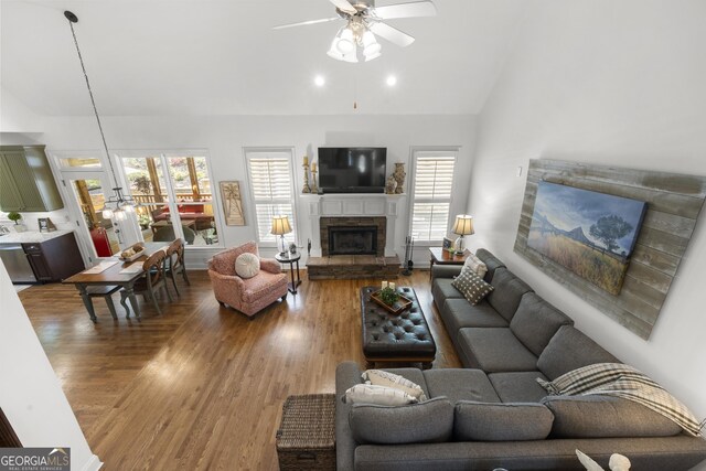 112 Pebblebrooke Run, Canton, GA 30115 - living room with a stone fireplace, ceiling fan, lofted ceiling, and wood finished floors