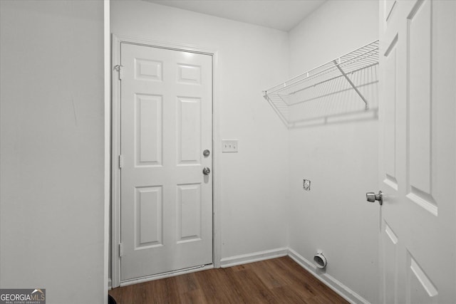 laundry room featuring laundry area, baseboards, dark wood-type flooring, and electric dryer hookup