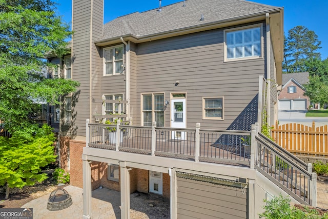 3641 Carriage Glen Way, Dacula, GA 30019 - back of house featuring a fire pit, a chimney, a patio area, a deck, and a shingled roof