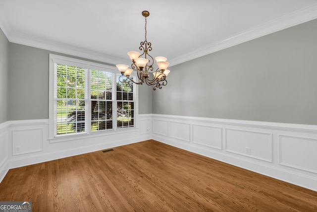 3641 Carriage Glen Way, Dacula, GA 30019 - unfurnished dining area with a chandelier, wainscoting, ornamental molding, and wood finished floors