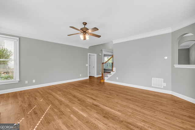 3641 Carriage Glen Way, Dacula, GA 30019 - spare room featuring a ceiling fan, crown molding, plenty of natural light, light wood-style floors, and stairway