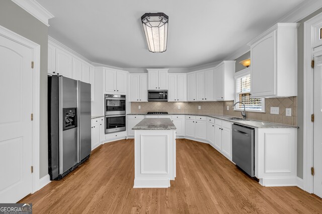 3641 Carriage Glen Way, Dacula, GA 30019 - kitchen with stainless steel appliances, white cabinets, light wood-style floors, and a sink