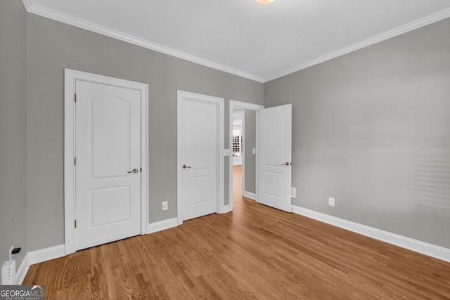 3641 Carriage Glen Way, Dacula, GA 30019 - unfurnished bedroom with ornamental molding, baseboards, and wood finished floors