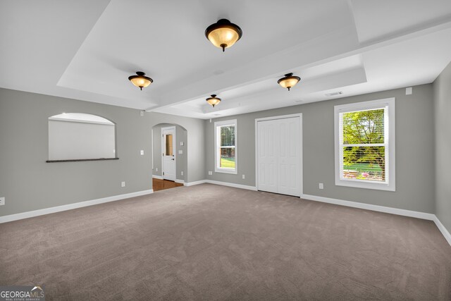 3641 Carriage Glen Way, Dacula, GA 30019 - carpeted empty room with a tray ceiling, arched walkways, plenty of natural light, and baseboards