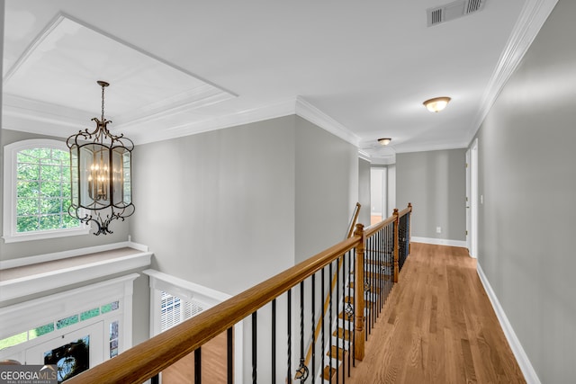 3641 Carriage Glen Way, Dacula, GA 30019 - corridor with an upstairs landing, light wood-style floors, a chandelier, crown molding, and baseboards