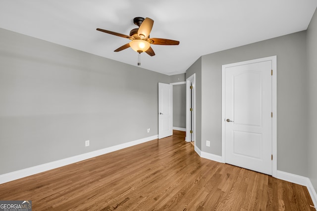 3641 Carriage Glen Way, Dacula, GA 30019 - unfurnished bedroom with wood finished floors, baseboards, and a ceiling fan