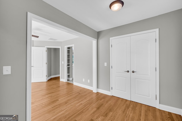 3641 Carriage Glen Way, Dacula, GA 30019 - unfurnished bedroom with light wood-type flooring, baseboards, and a closet