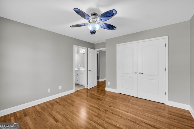 3641 Carriage Glen Way, Dacula, GA 30019 - unfurnished bedroom with baseboards, wood finished floors, a closet, and connected bathroom