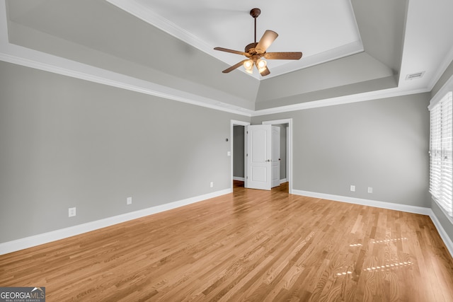 3641 Carriage Glen Way, Dacula, GA 30019 - unfurnished bedroom with a tray ceiling, ornamental molding, baseboards, light wood finished floors, and ceiling fan