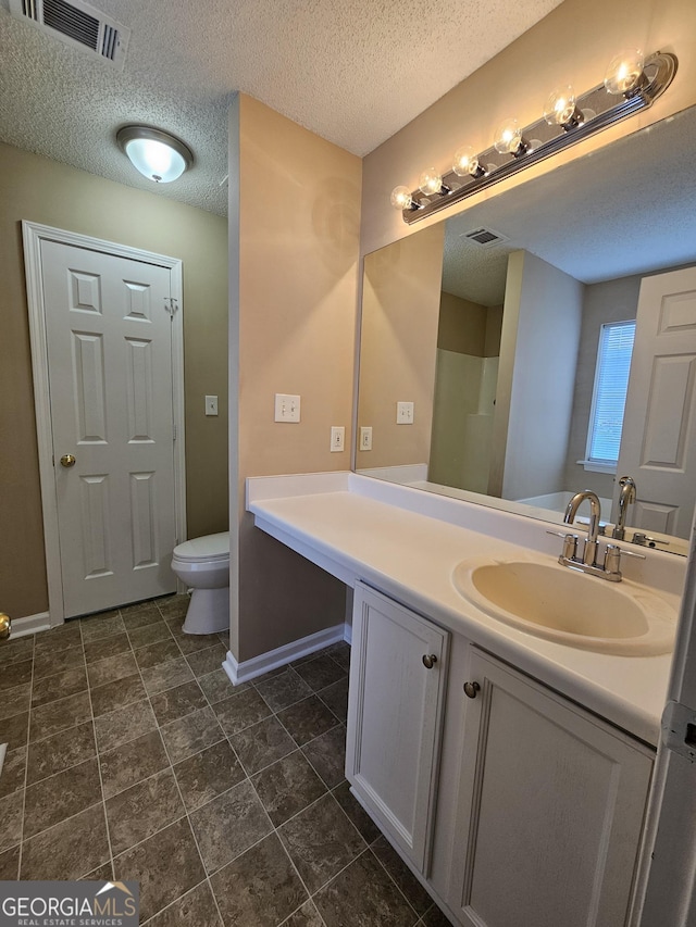 3081 Regal Dr, Mcdonough, GA 30253 - bathroom with vanity, a textured ceiling, baseboards, and visible vents