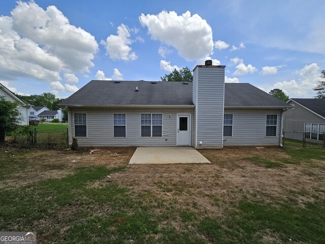 3081 Regal Dr, Mcdonough, GA 30253 - back of property with a lawn, a patio area, and fence
