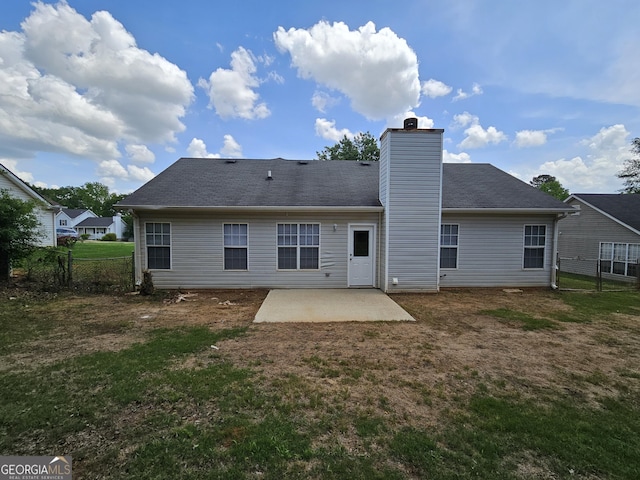 back of house with fence, a patio, and a yard