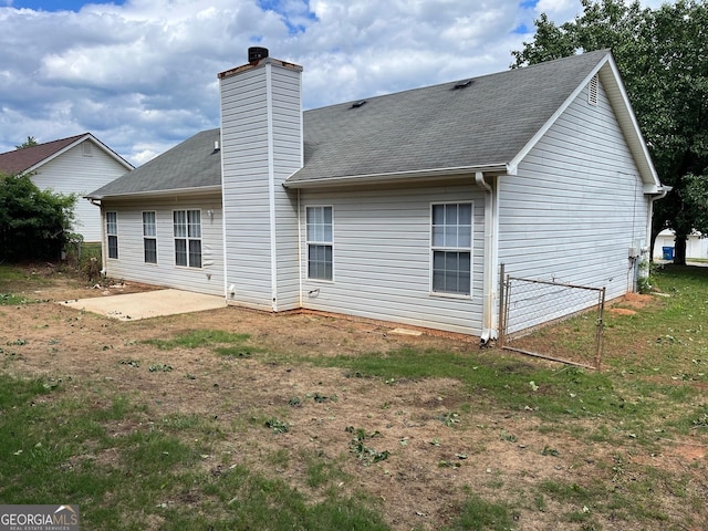 3081 Regal Dr, Mcdonough, GA 30253 - rear view of house featuring a chimney, a patio area, roof with shingles, and fence