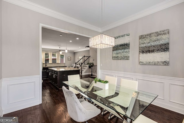 5934 Norfolk Chase Rd, Peachtree Corners, GA 30092 - dining room with ornamental molding, an inviting chandelier, a wainscoted wall, stairway, and dark wood-style floors