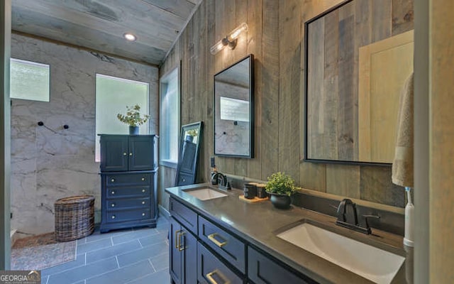 full bathroom featuring double vanity, a sink, and tile patterned flooring