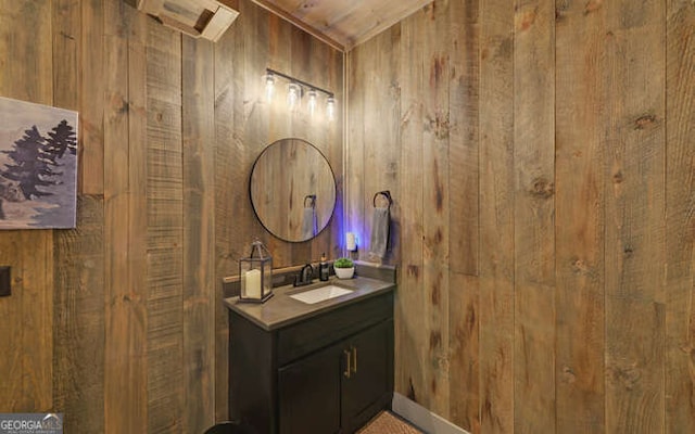 bathroom with vanity and wood walls