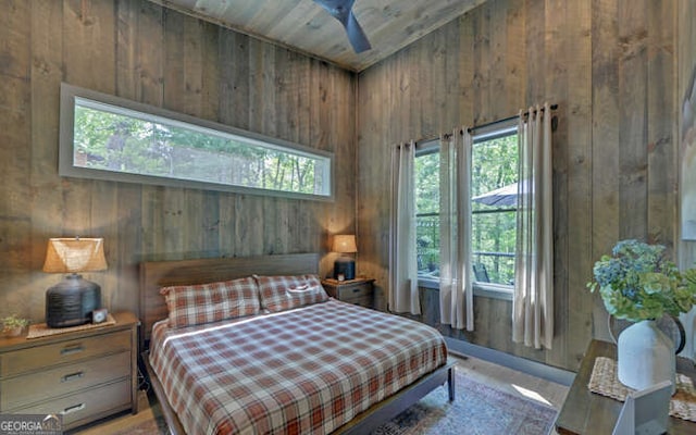 bedroom featuring wood walls