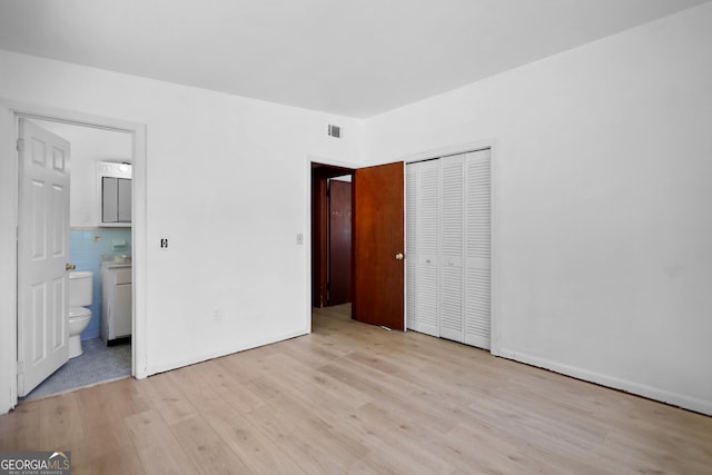 4365 US Highway 341, Jesup, GA 31545 - unfurnished bedroom with light wood-style flooring, a closet, and ensuite bathroom