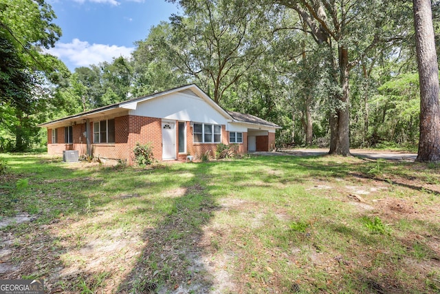 4365 US Highway 341, Jesup, GA 31545 - single story home with brick siding, a front yard, an attached garage, and central air condition unit