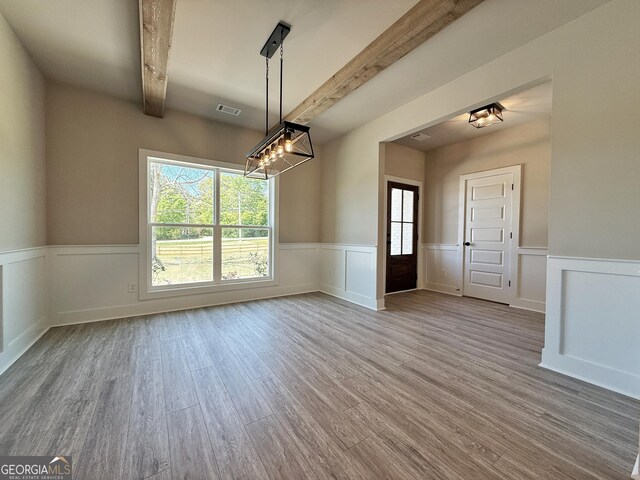 3132 Rosebud Rd Unit 1, Loganville, GA 30052 - unfurnished dining area with a notable chandelier, beamed ceiling, visible vents, and wood finished floors