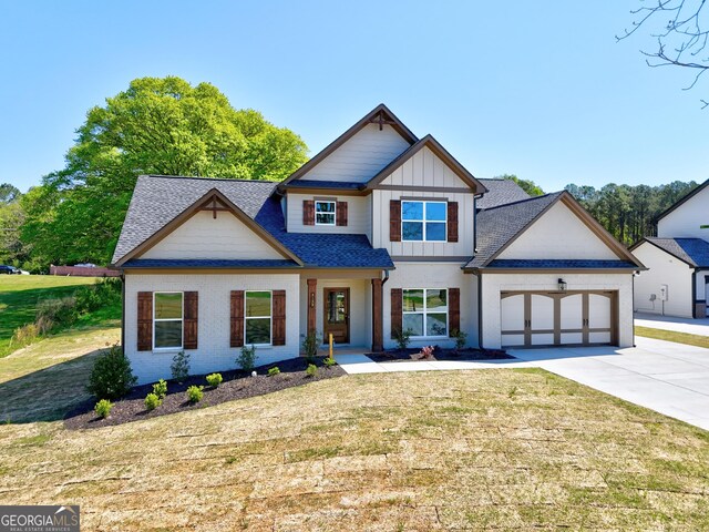3132 Rosebud Rd Unit 1, Loganville, GA 30052 - view of front facade featuring an attached garage, a front lawn, board and batten siding, and concrete driveway