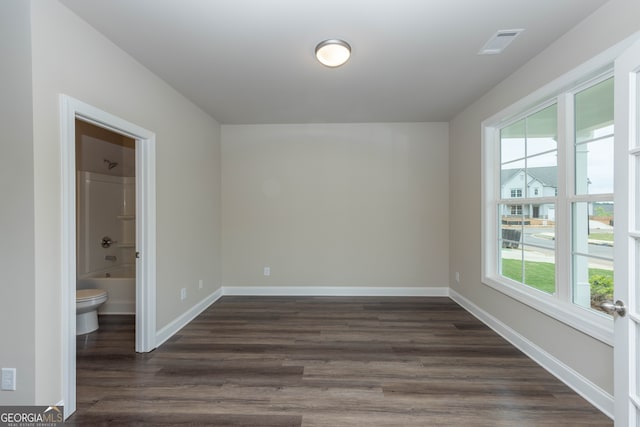 5587 Spring St, Flowery Branch, GA 30542 - spare room featuring healthy amount of natural light and dark wood finished floors