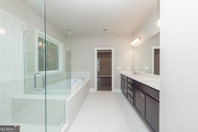 5587 Spring St, Flowery Branch, GA 30542 - full bath with double vanity, marble look tiles, a bath, and a shower with door